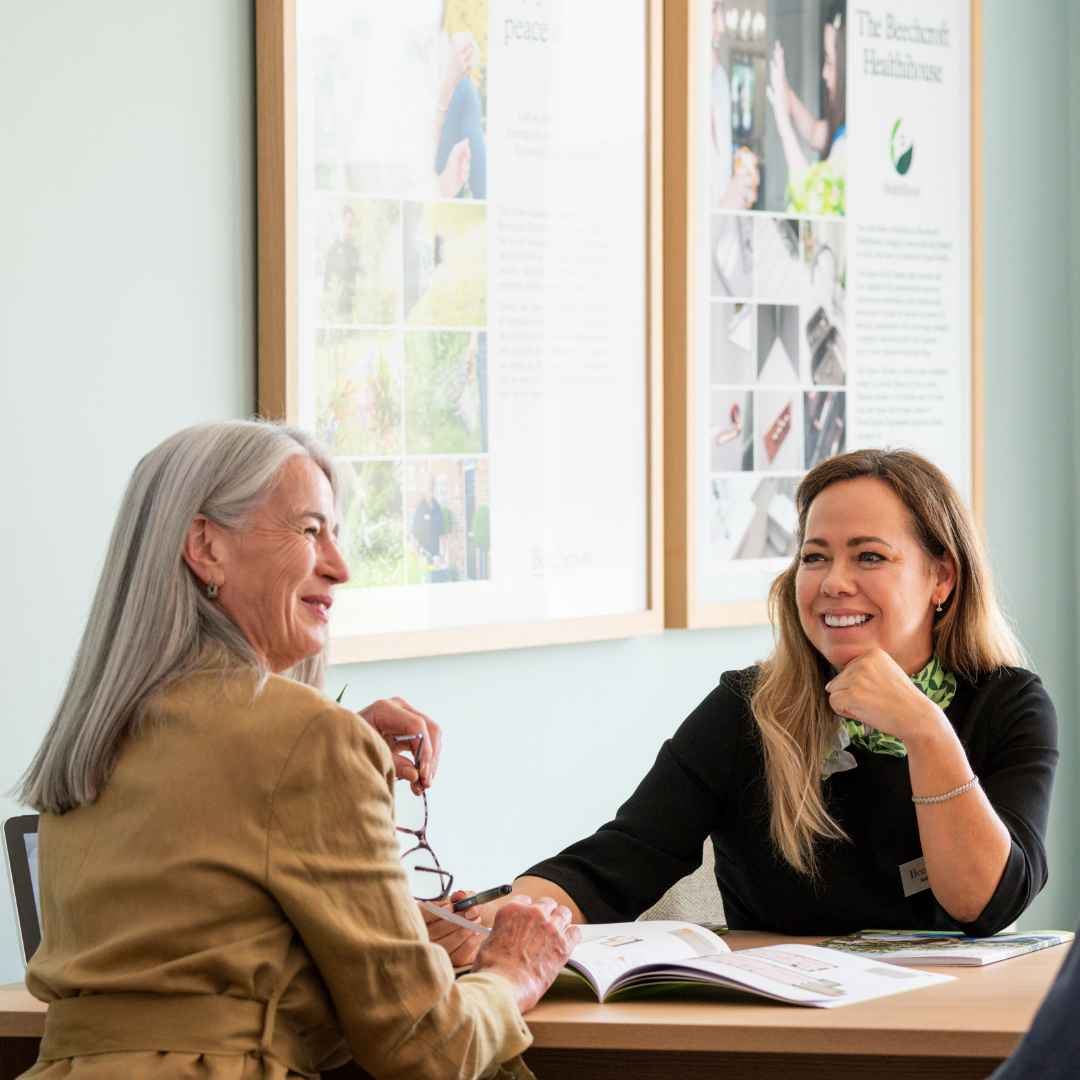 A lady speaking to an estate agent about a property