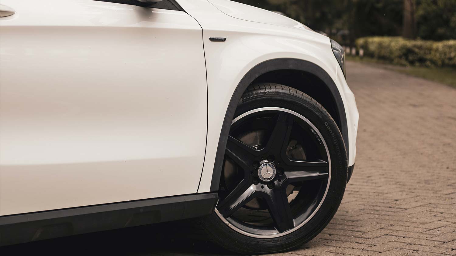 A close up of a white car's tyre