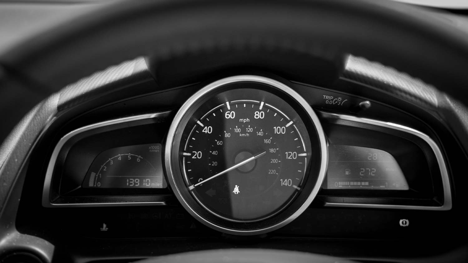 A close up of a car's speedometer