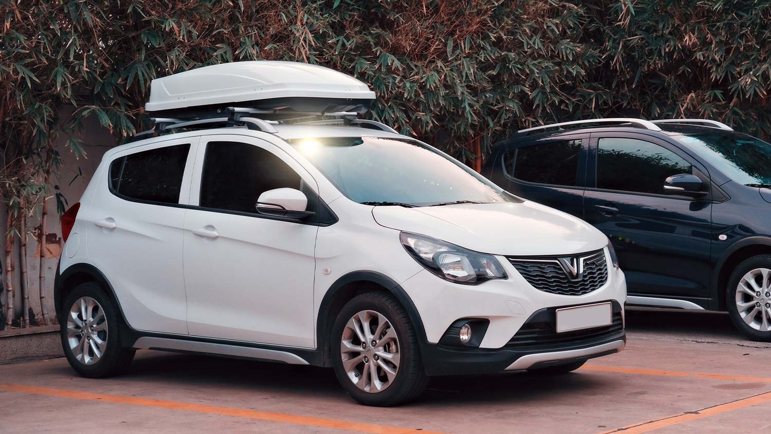 A white car with a roof box