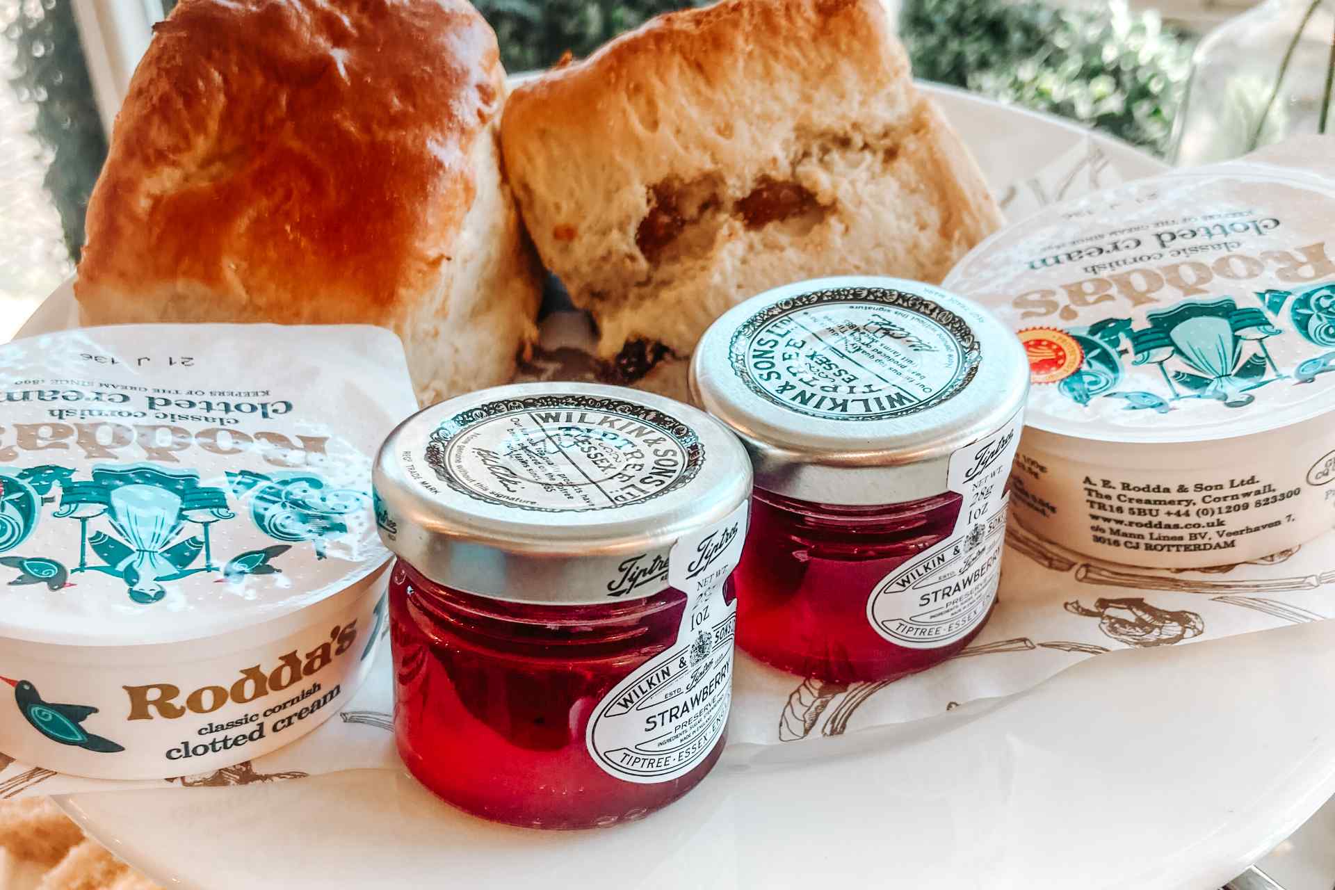 Scones, cream and jam on an afternoon tea plate in Huffkins, Burford.