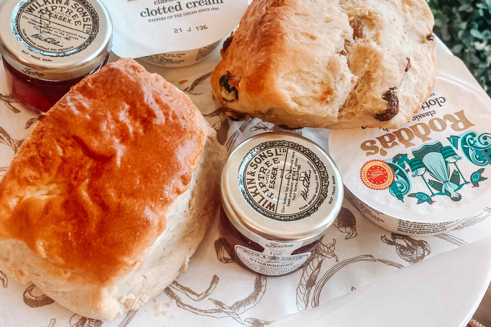 Scones, cream and jam on an afternoon tea plate in Huffkins, Burford.
