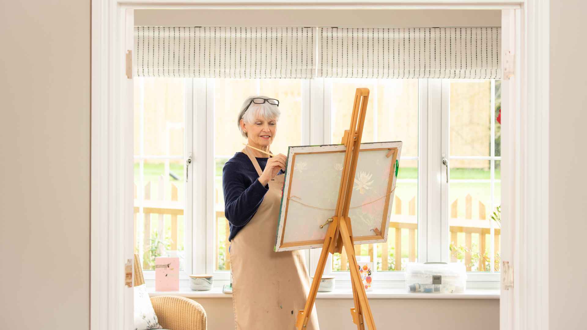 A lady painting in her home