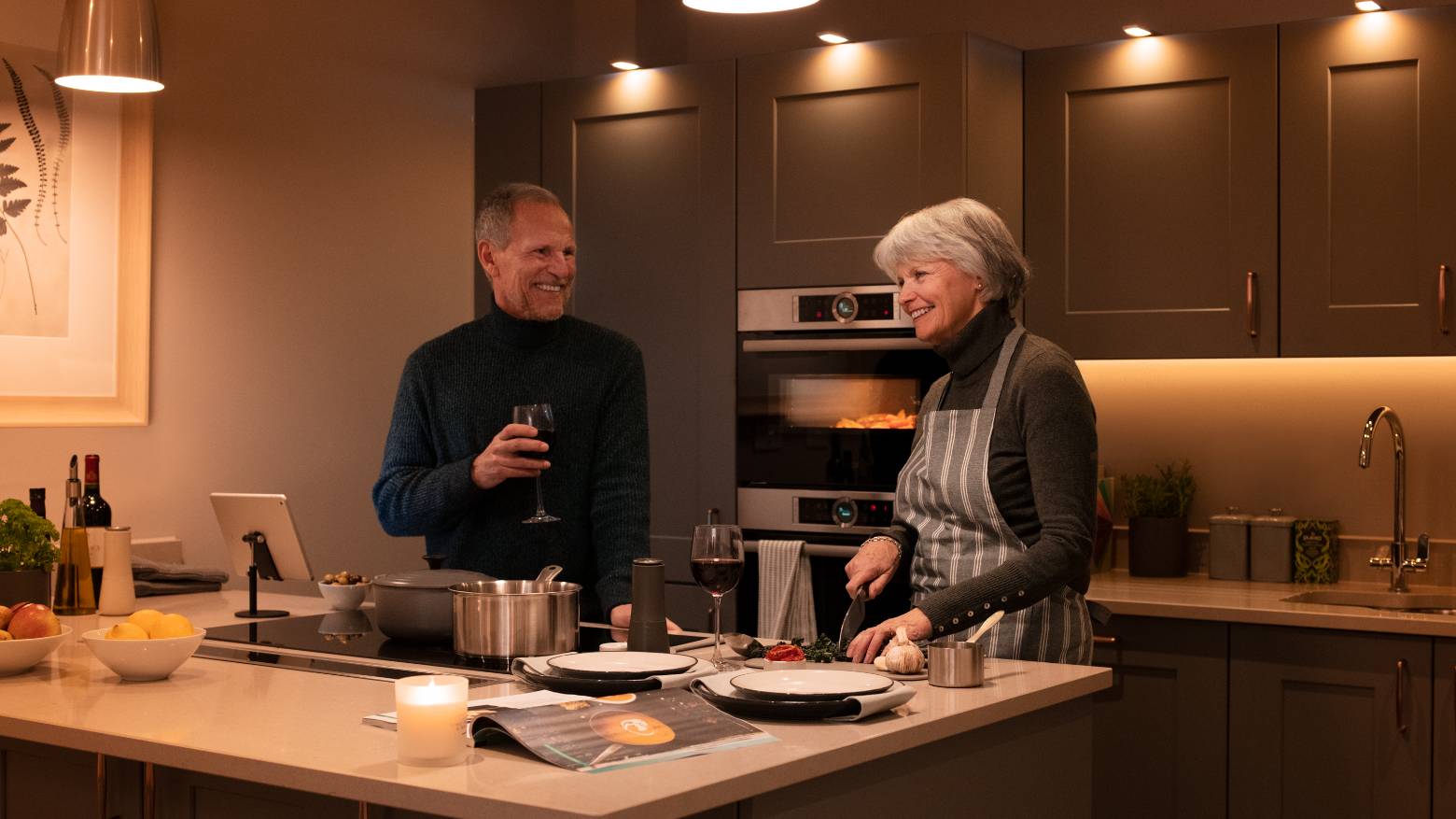 A couple cooking together in their kitchen