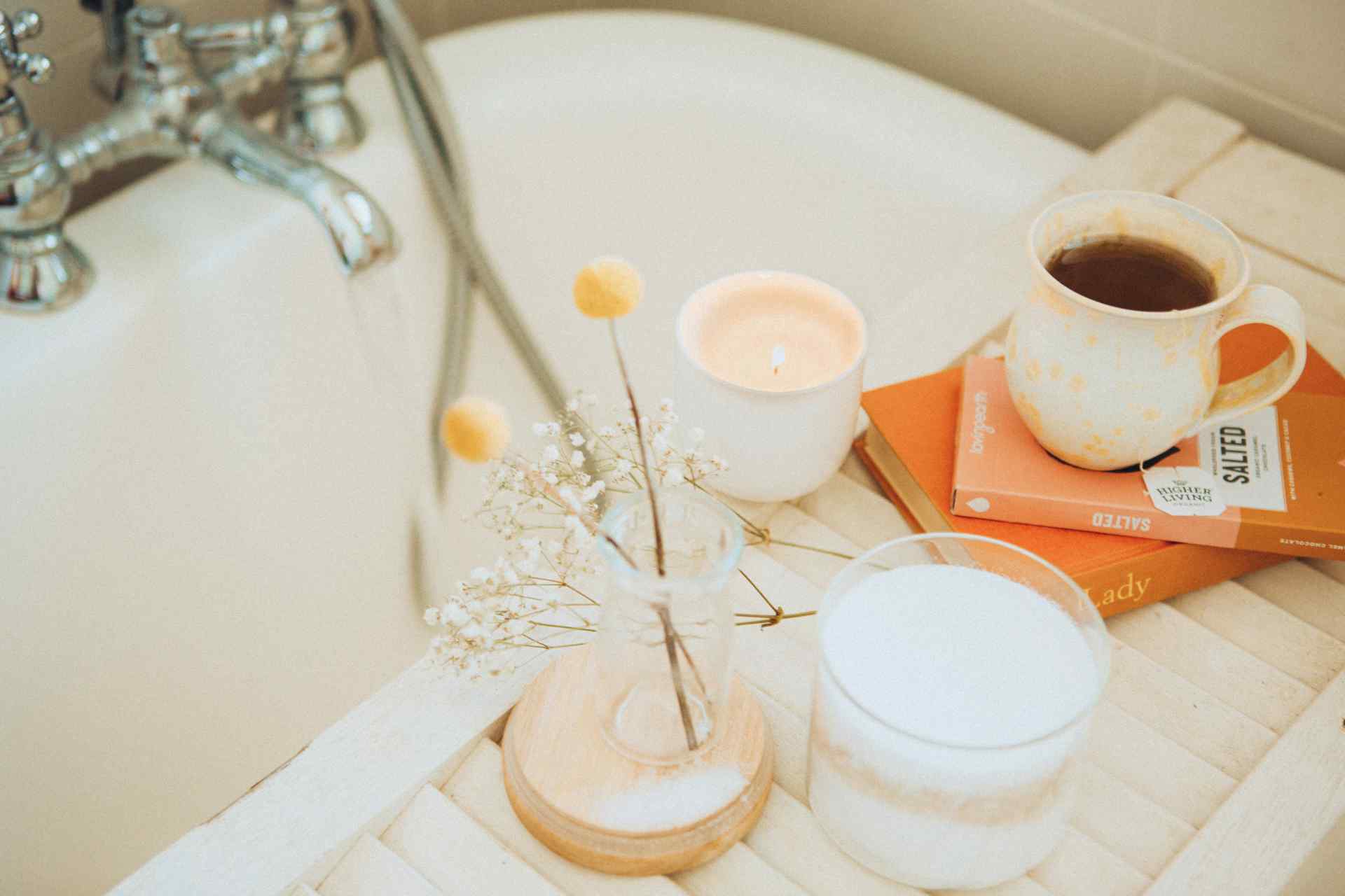 Bath tub with books and a cup of tea