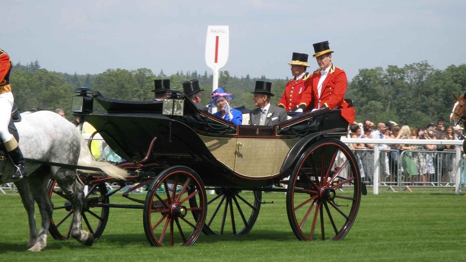 The Queen and Prince Philip riding in a carriage at Ascot