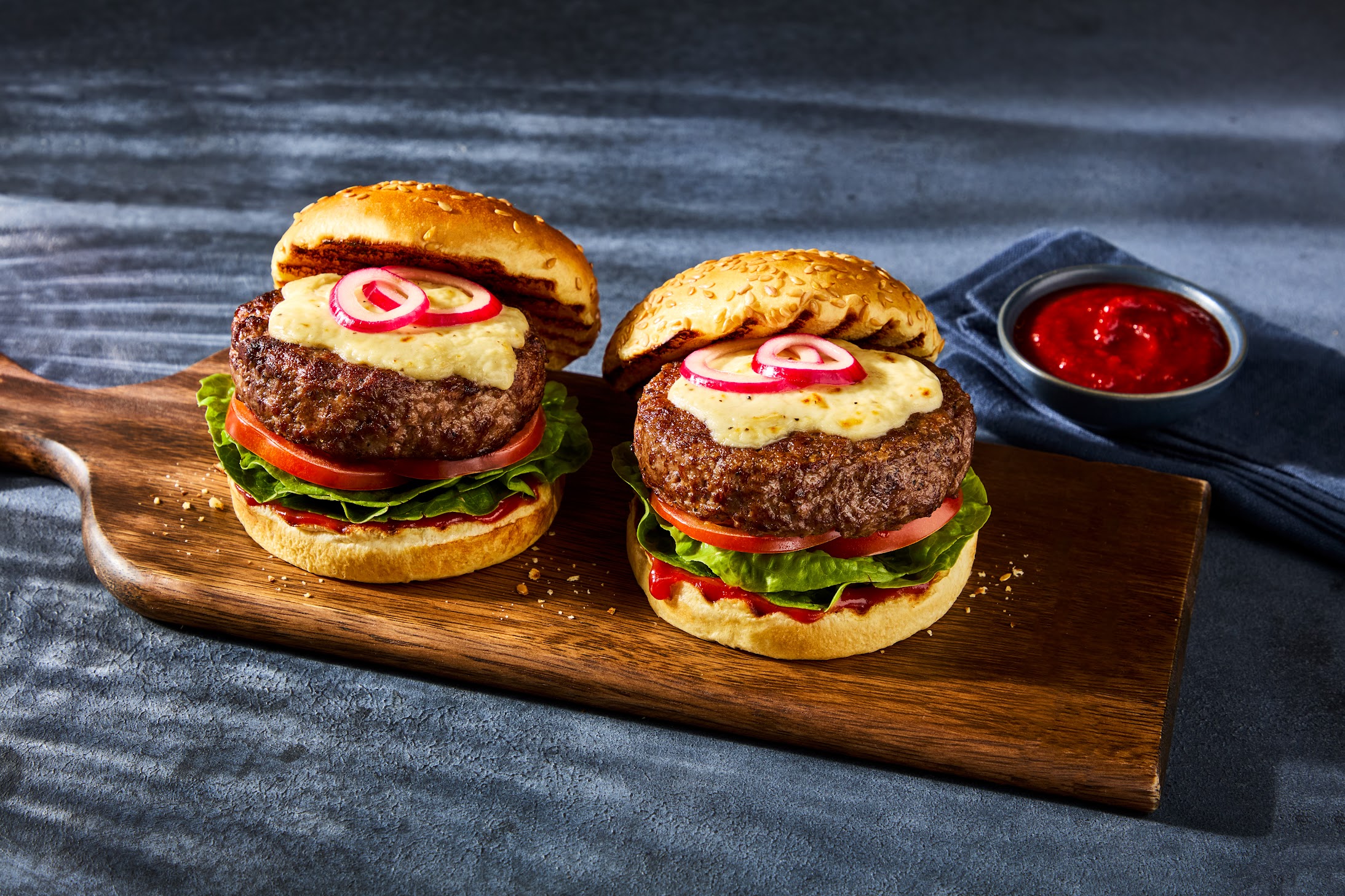 The best beef quater pounders by Morrisons on a wooden chopping board with ketchup