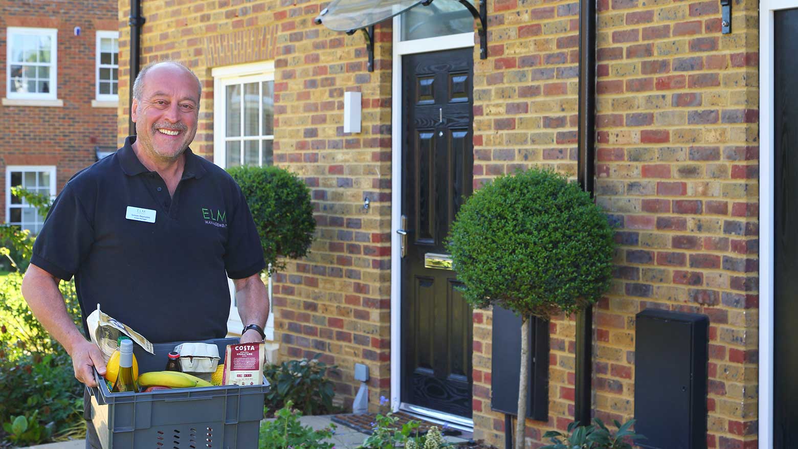 Estate manager holding a basket of supplies