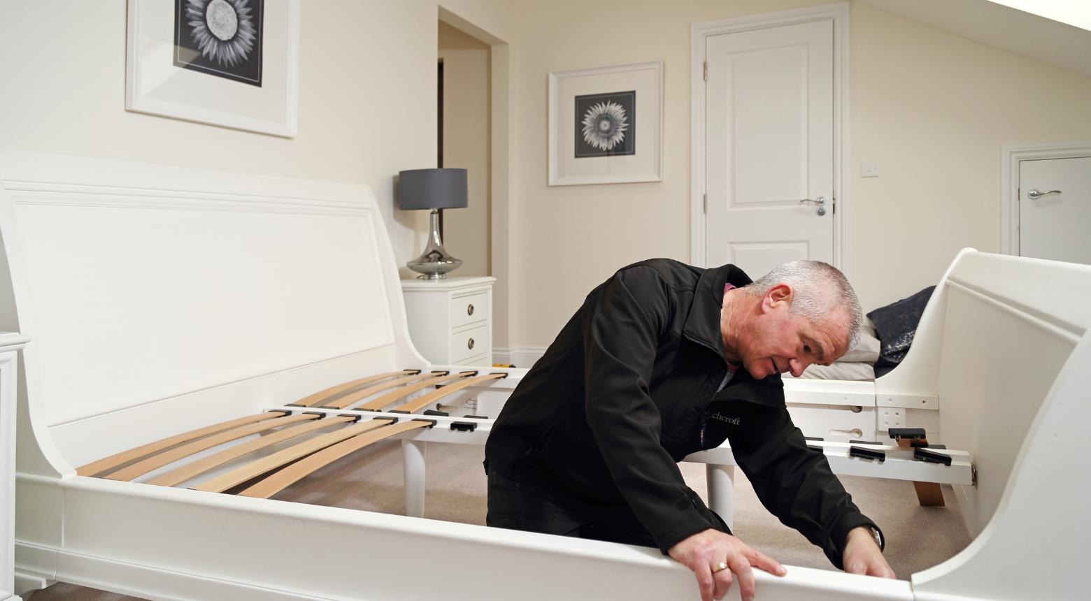 A Beechcroft handyman putting up some flatpack furniture