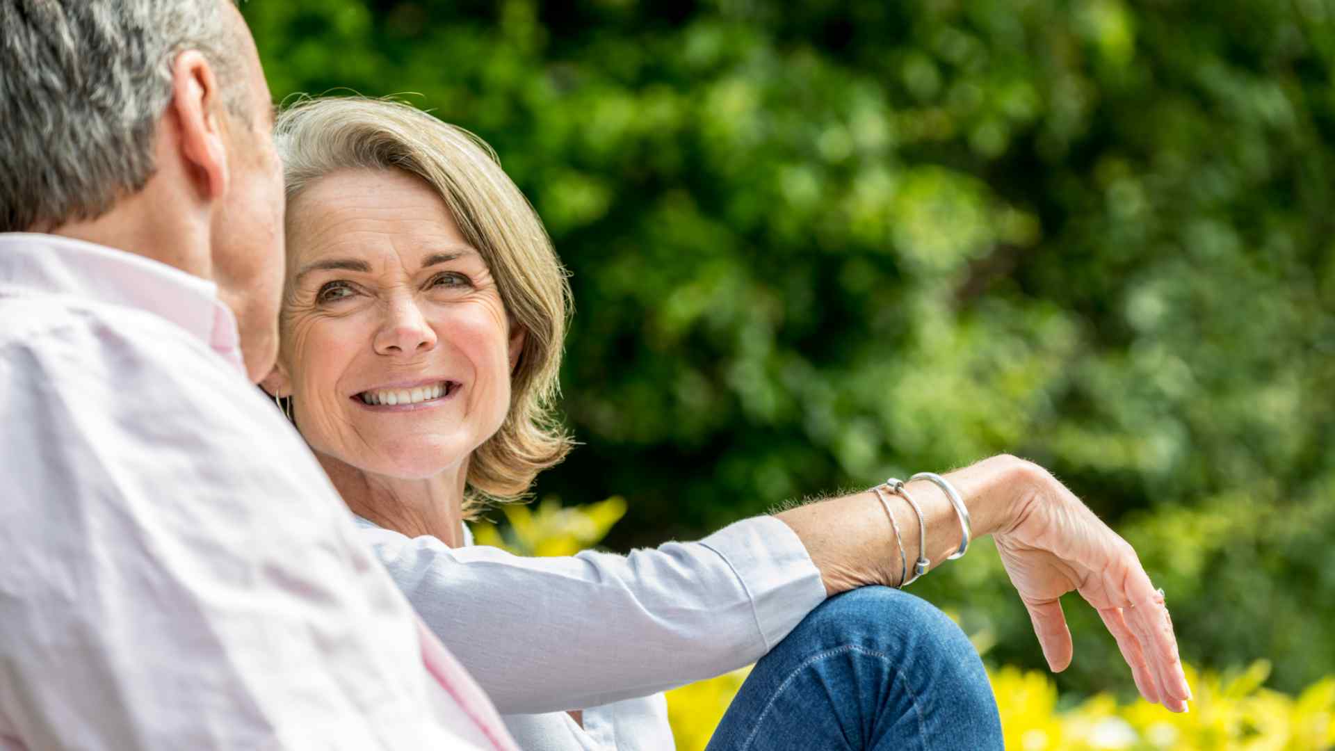 A man and a woman smiling in the garden