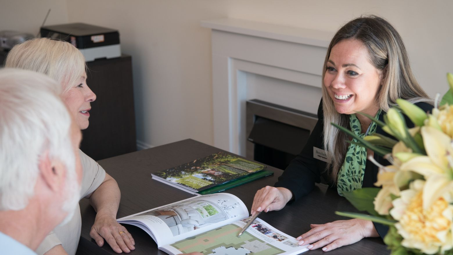 A Beechcroft Developments sales manager showing potential customers a brochure.