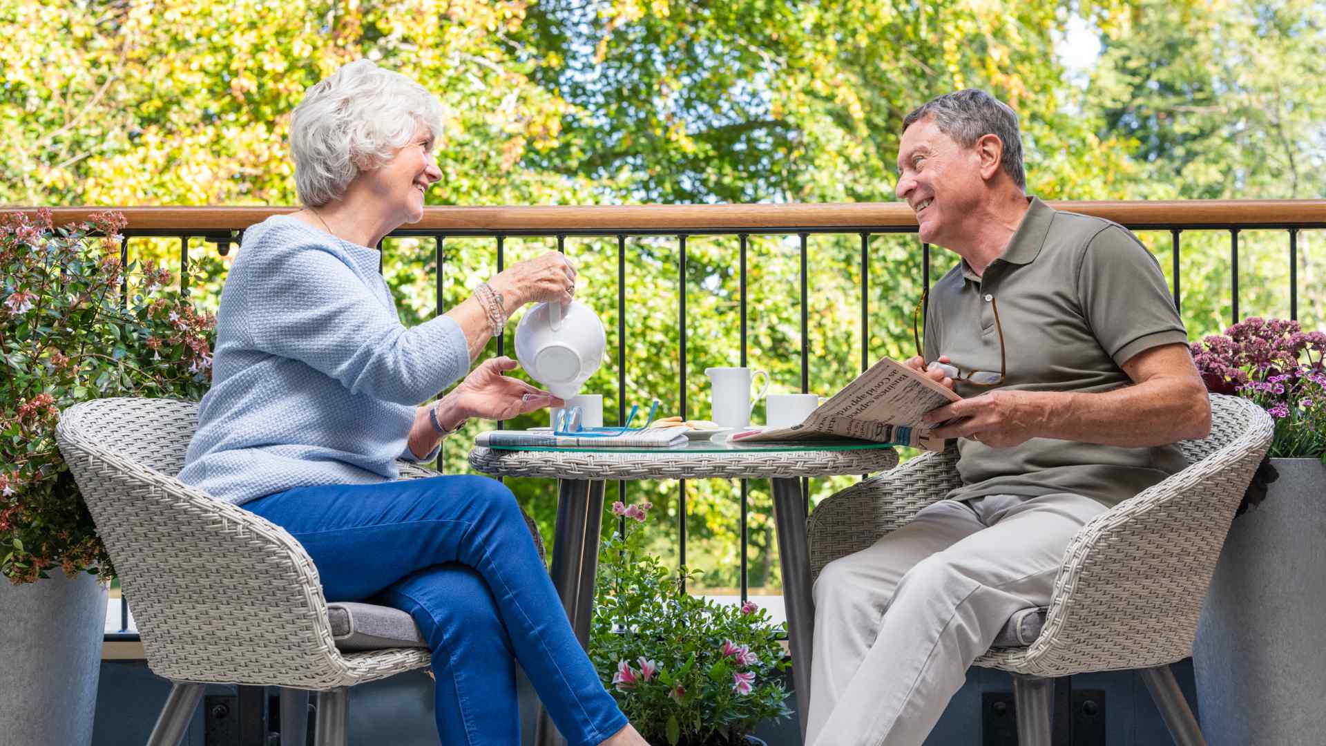 Two people drinking tea on their balcony