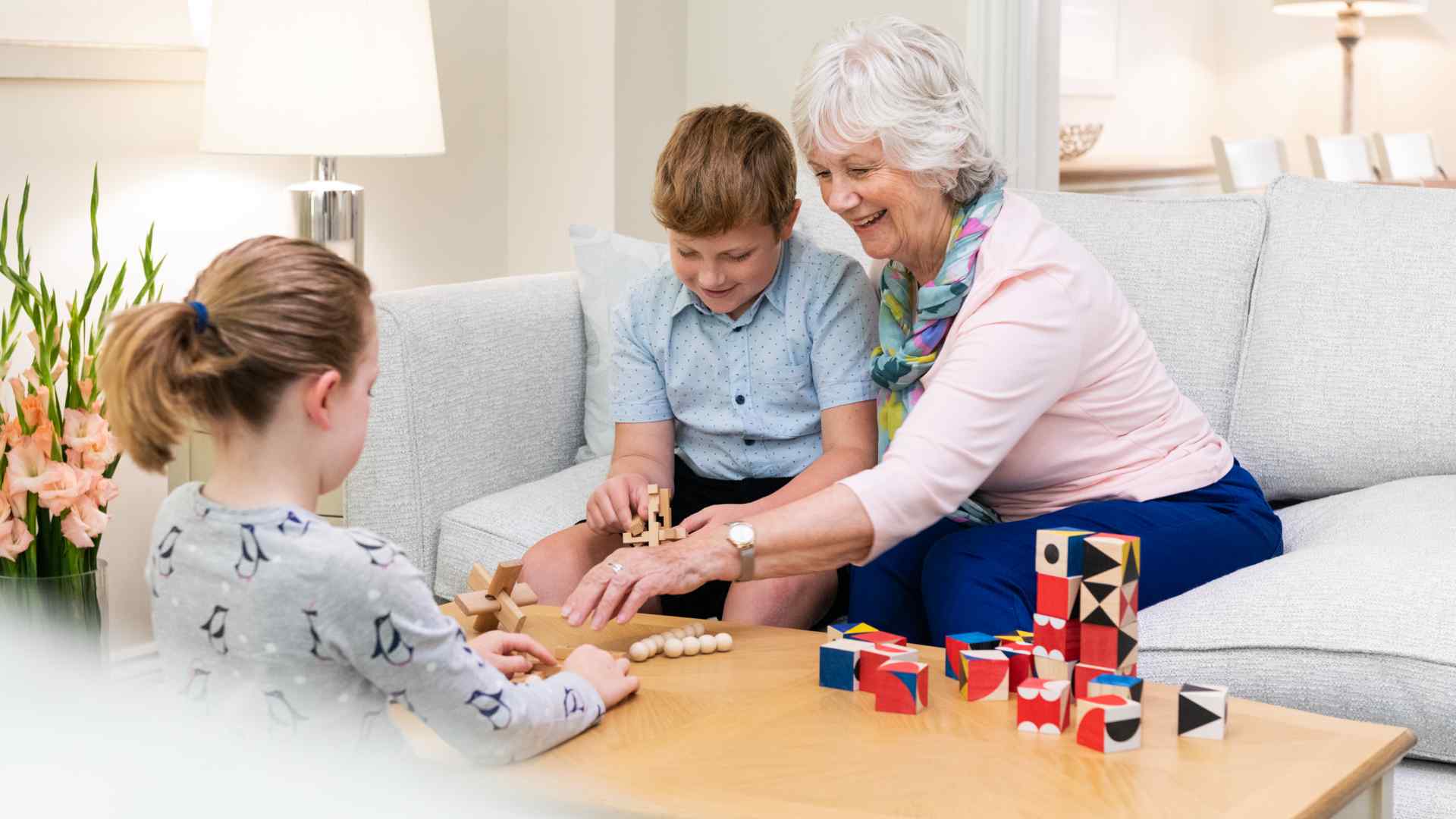 People raising a glass of red wine in a living room