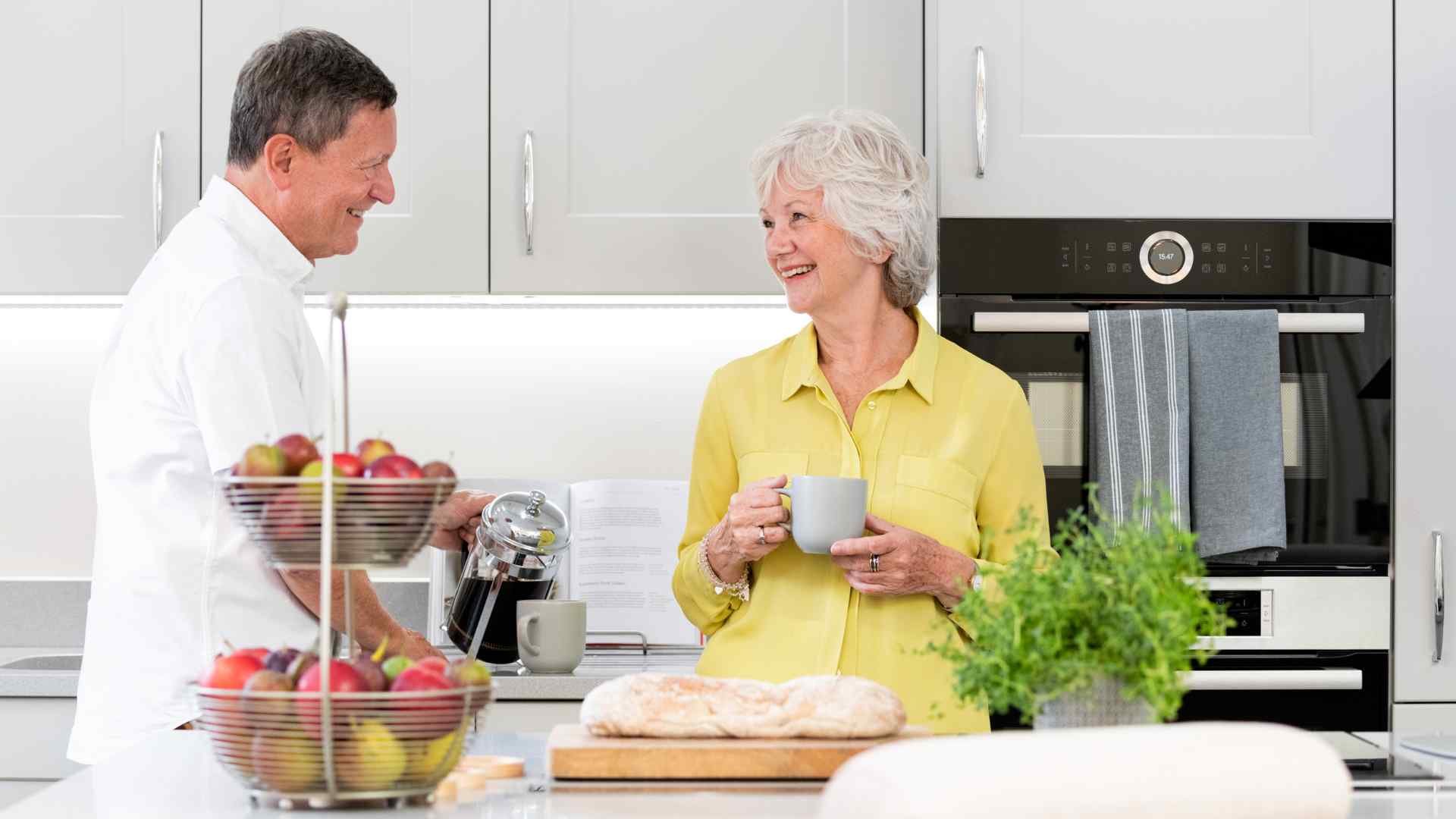 A couple talking in the kitchen