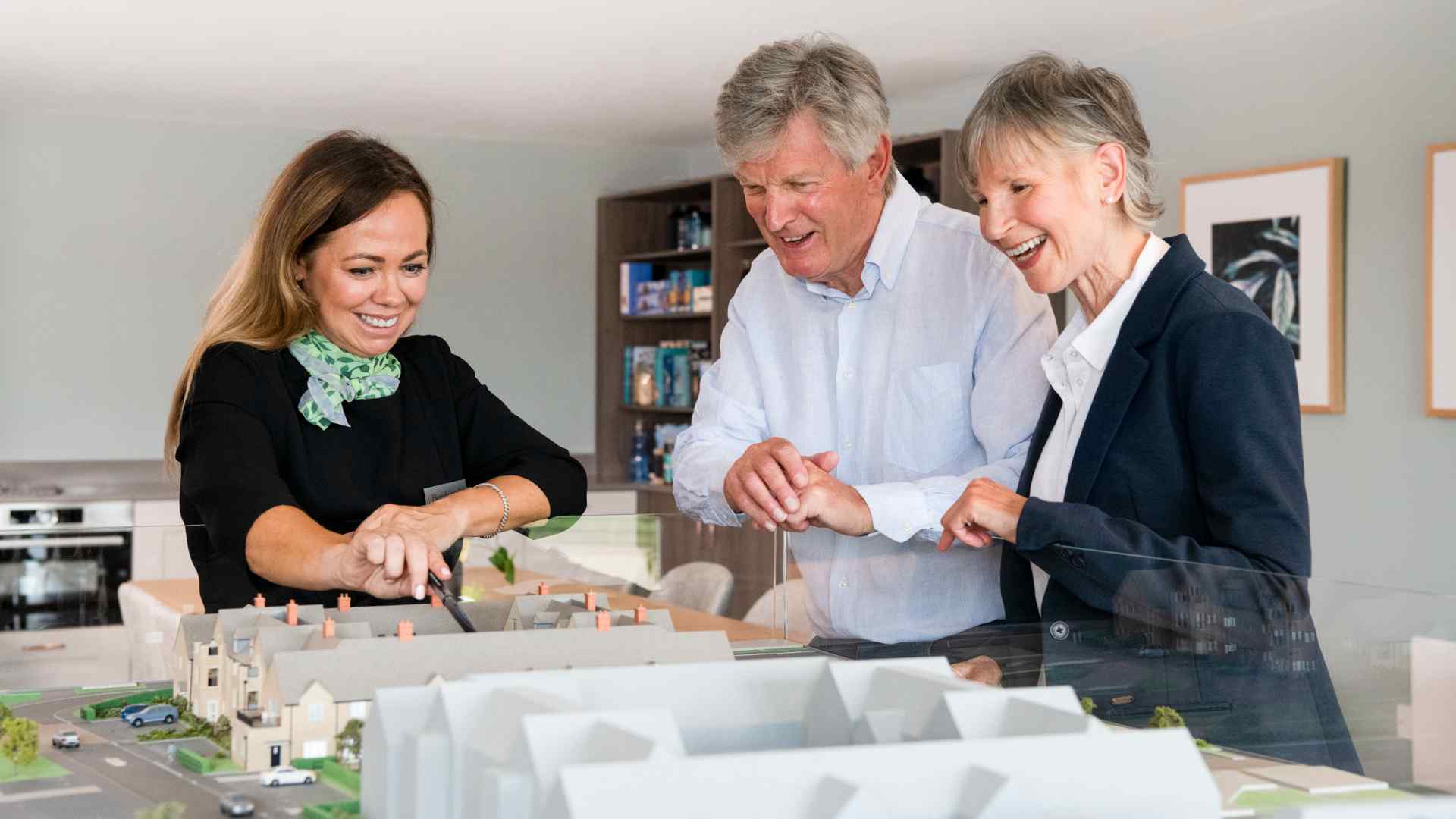 A Beechcroft Developments sales manager showing potential customers a model of a development. 