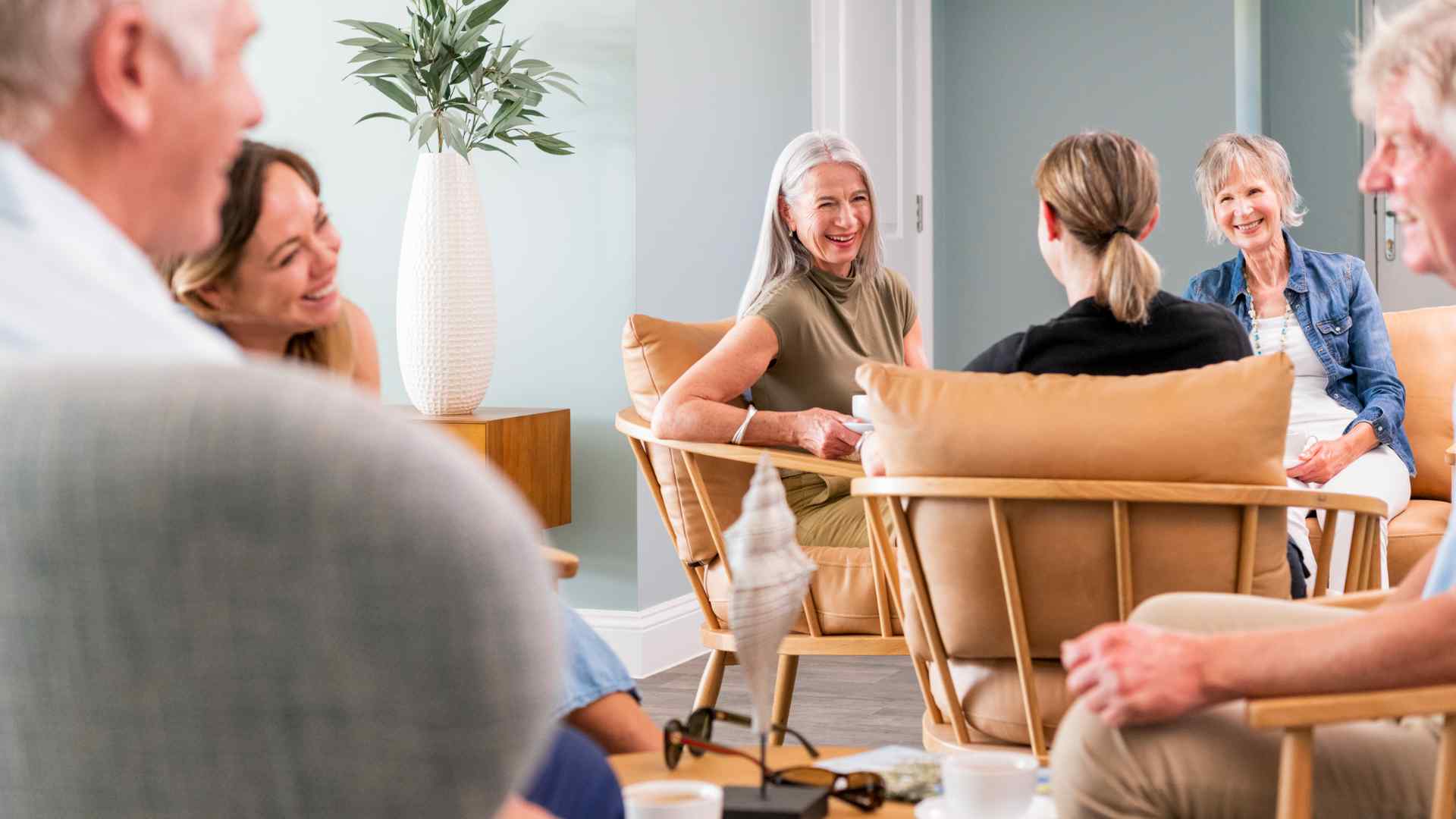 A group of people chatting in a communal lounge