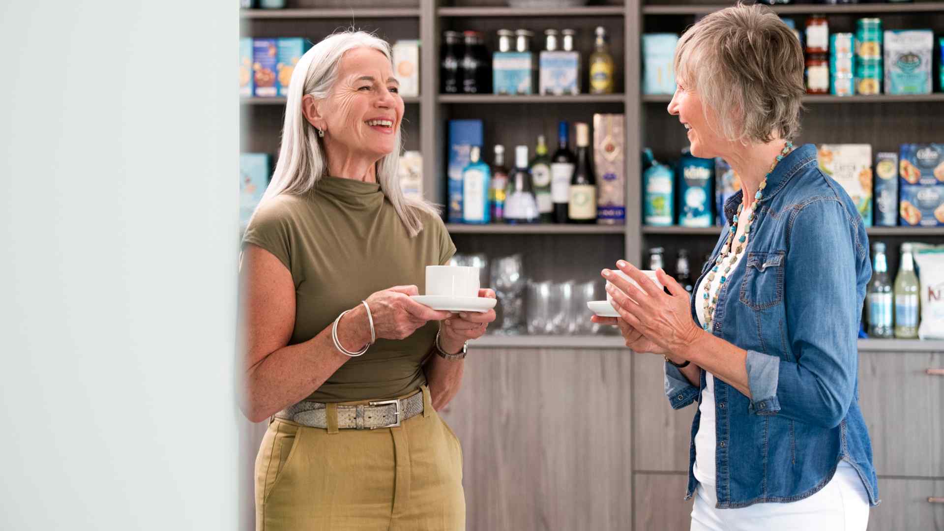 Two people drinking tea in the communal lounge