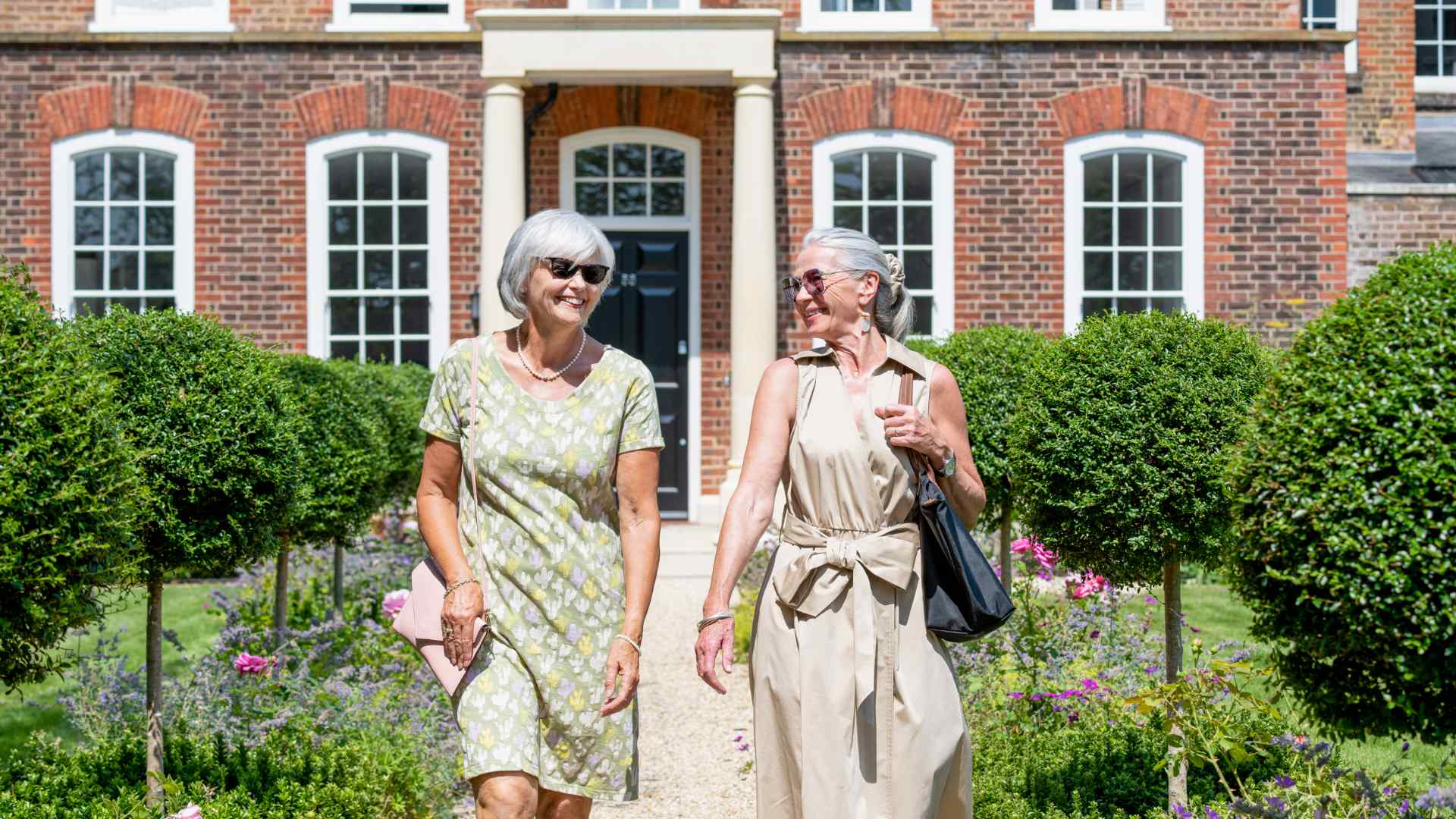 A dining table surrounded by windows and curtains