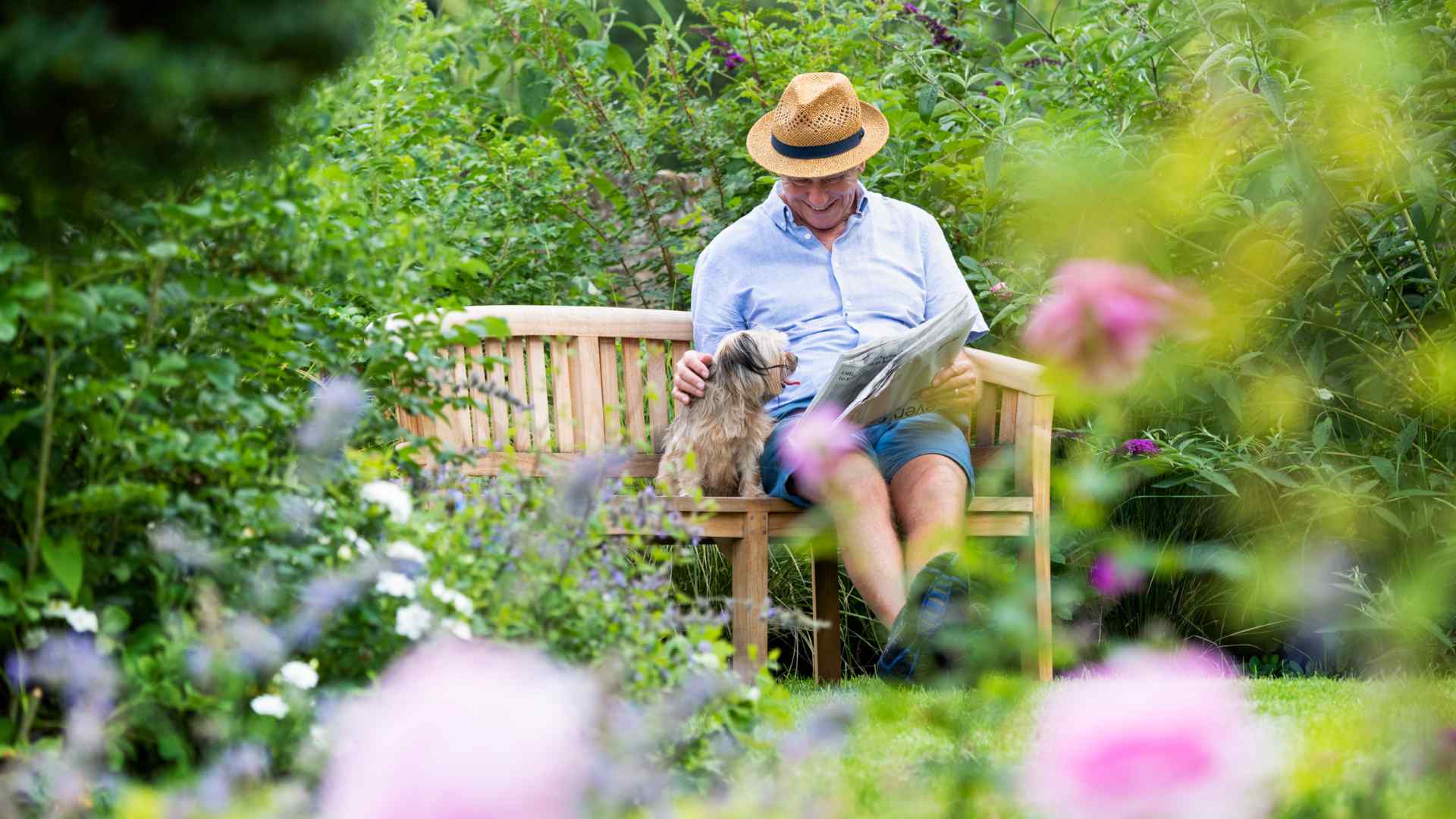 A Beechcroft Developments Estate Manager walking through the grounds of a development with cleaning supplies.