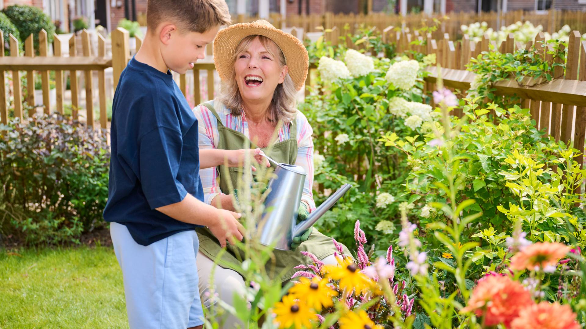 Woman gardening with a child at Castle Mews, Watlington