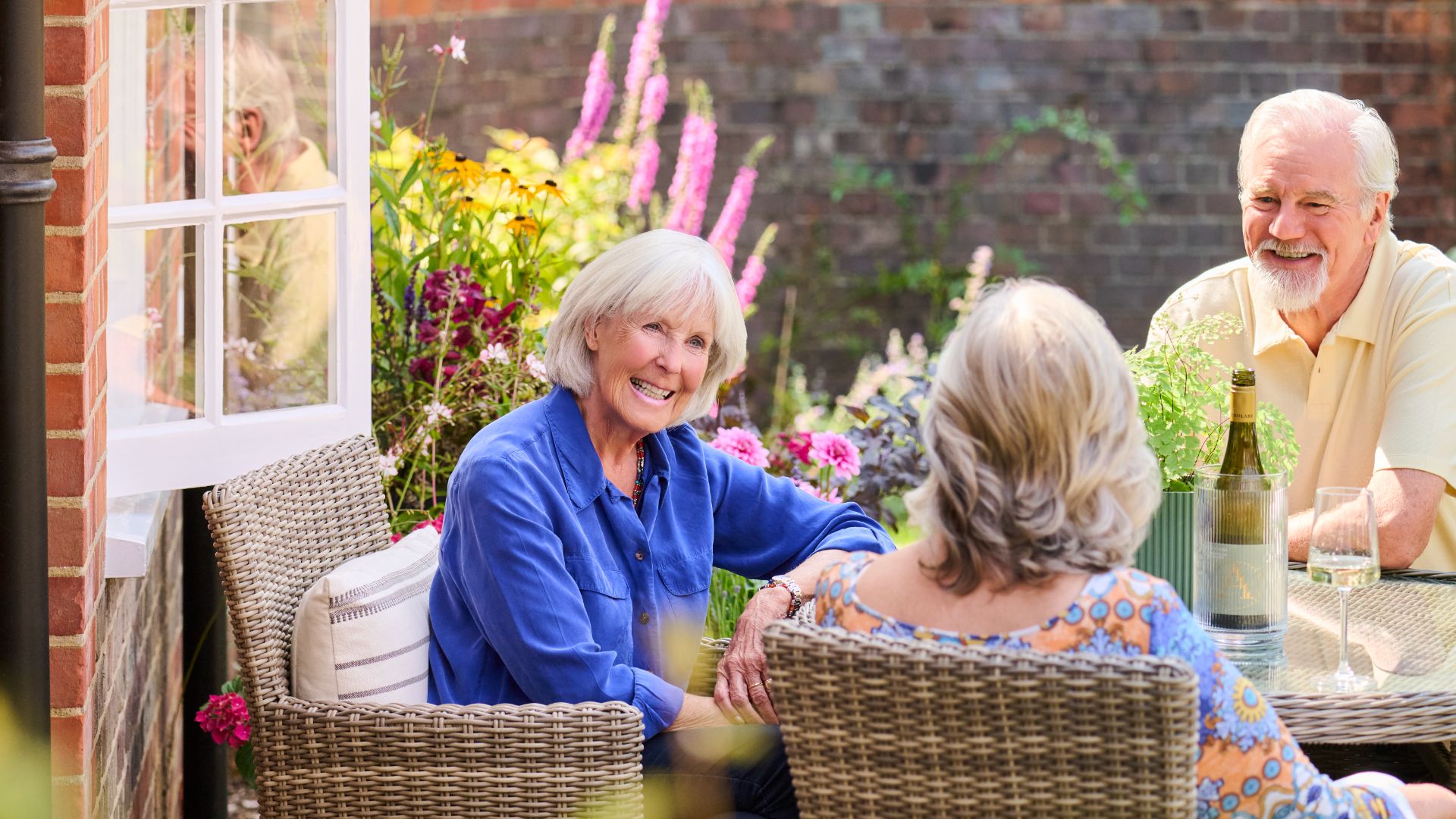 Four people having a cup of tea in a garden