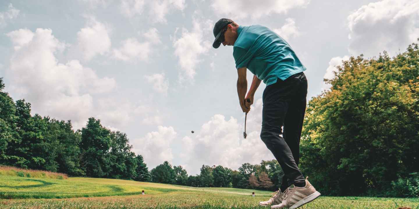 A man playing golf. 