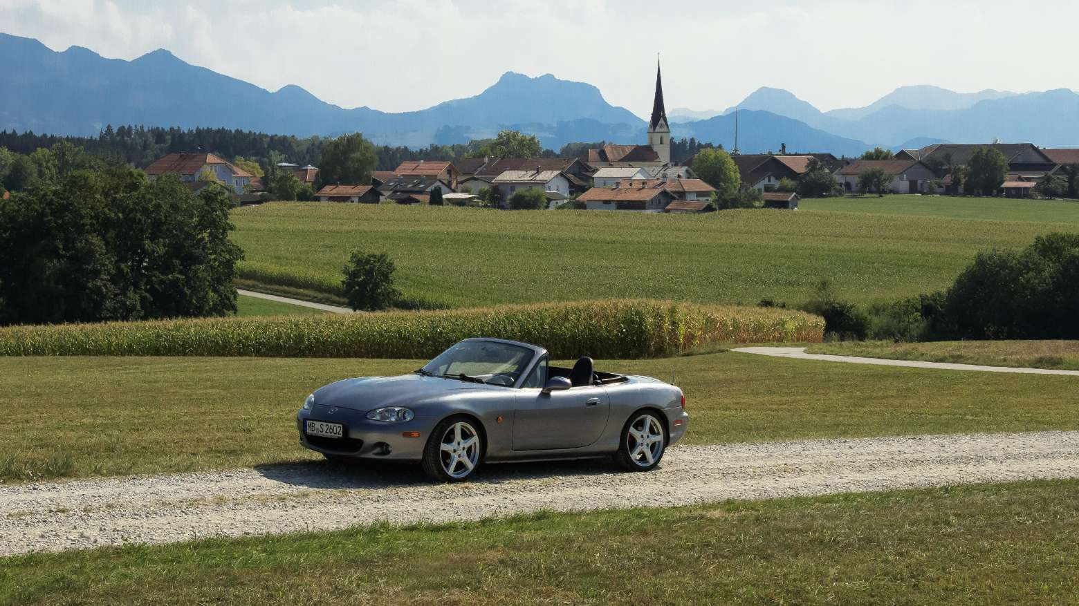 A photo of a Mazda MX5 in the countryside.