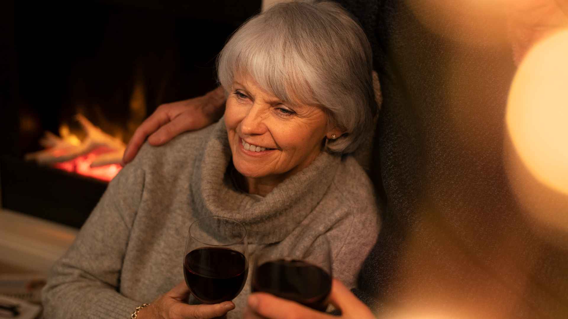 A woman enjoying a glass of red wine