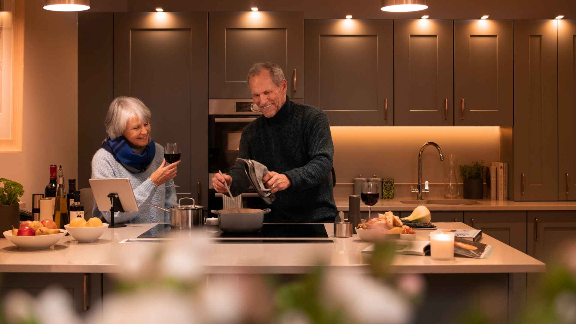 A couple cooking together in their kitchen