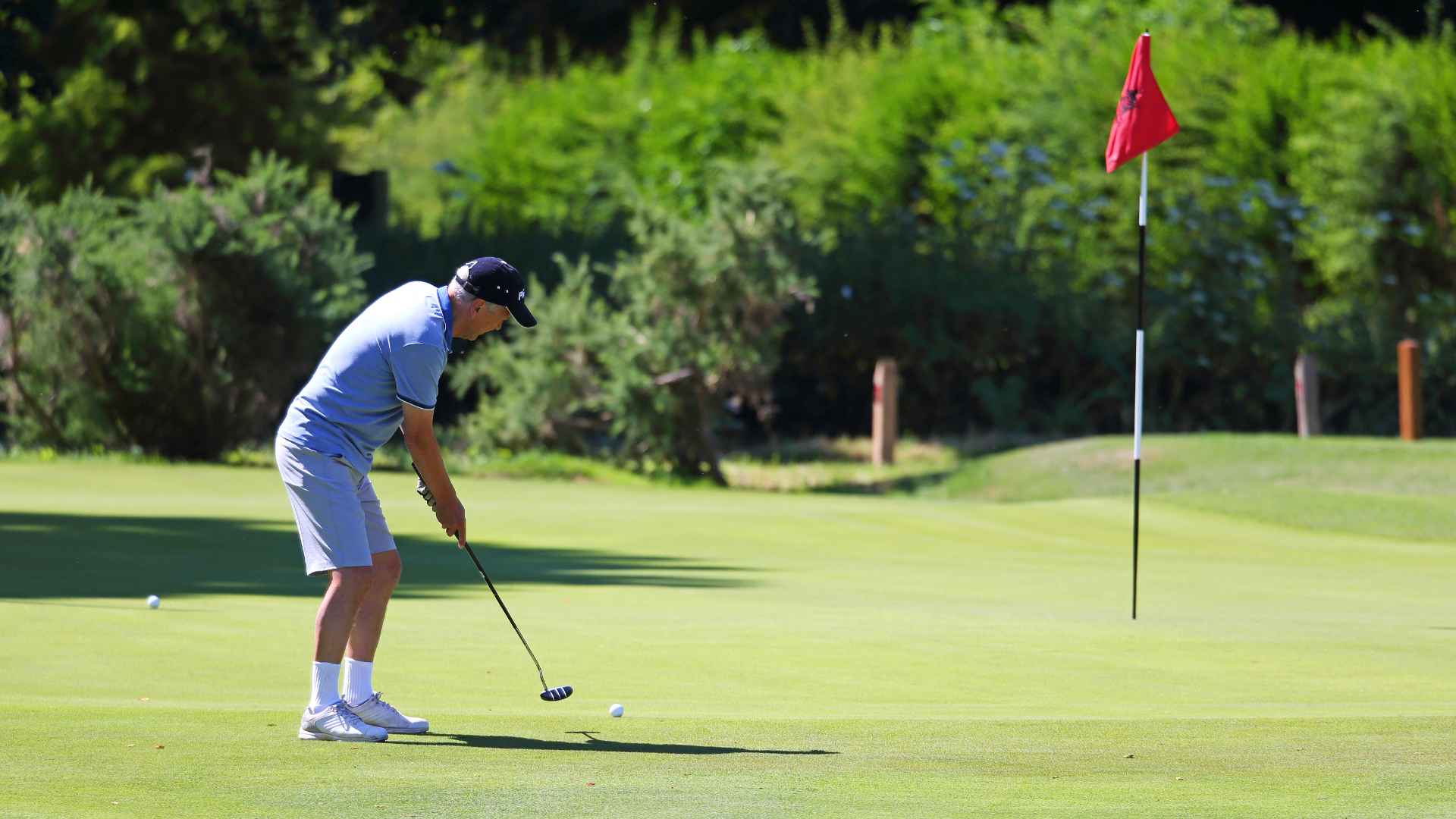 A man playing golf on a putting green