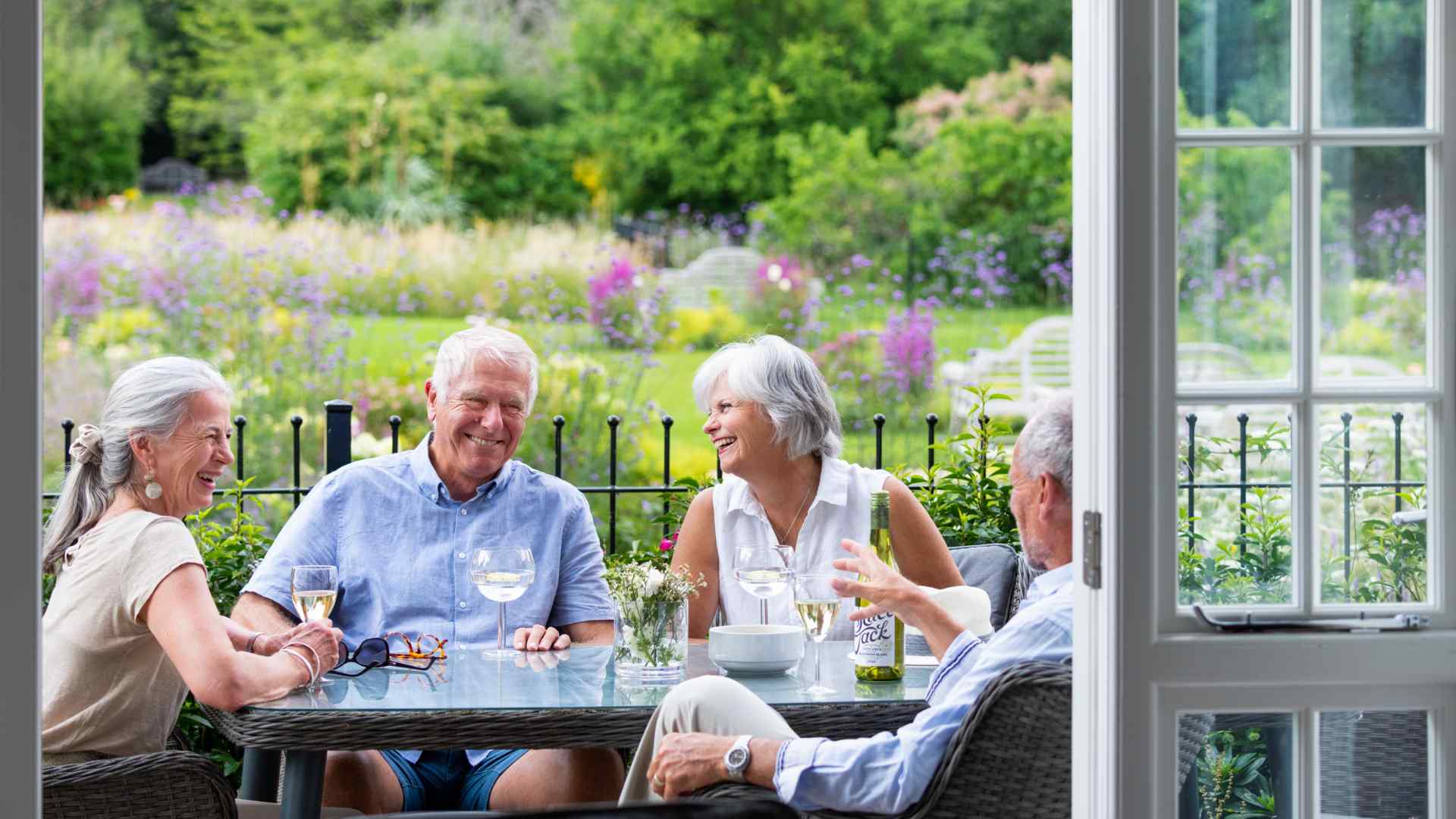 Four people sat around a table in their garden