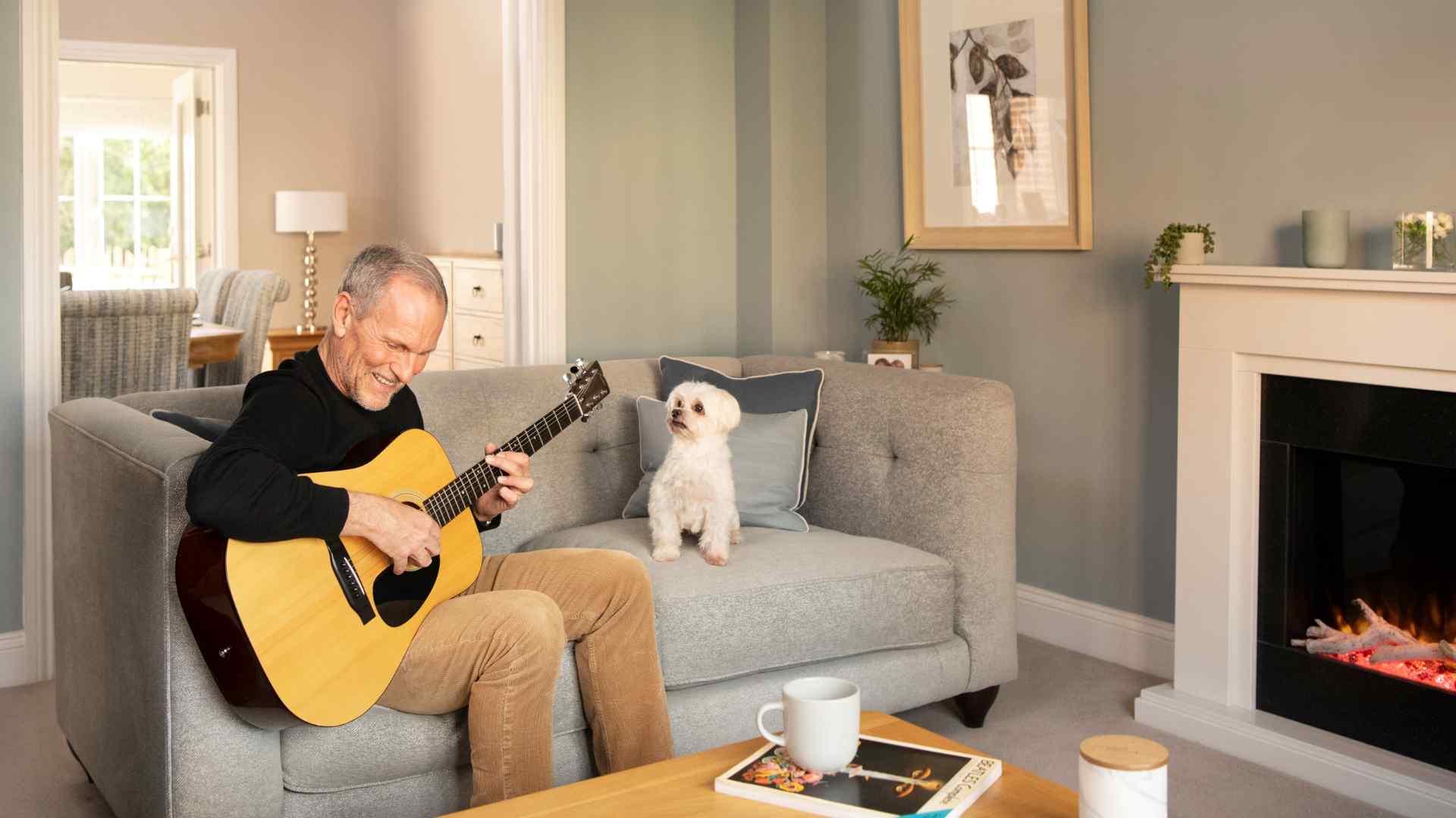 A man playing his guitar