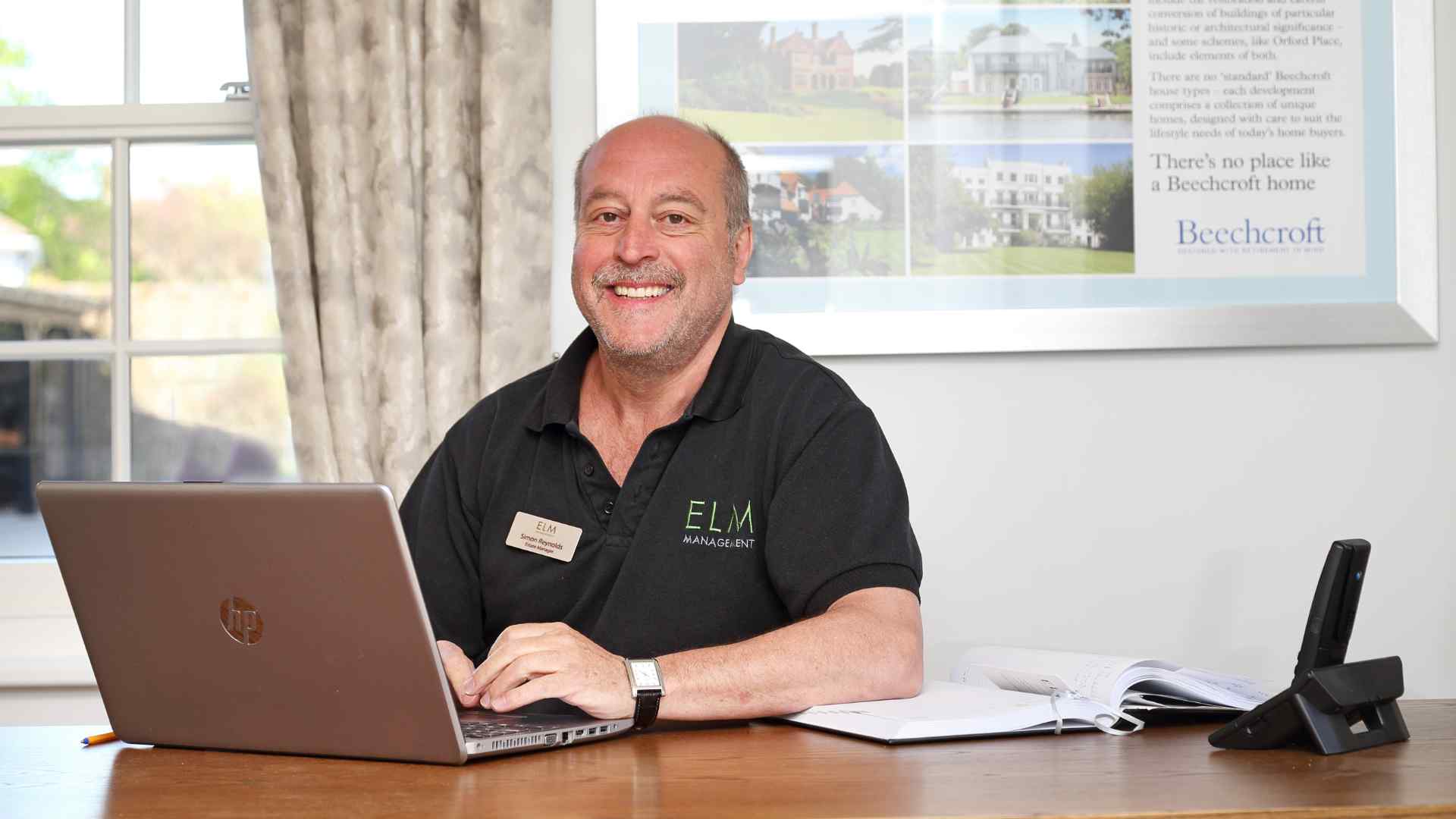 An Estate Manager sat at his desk