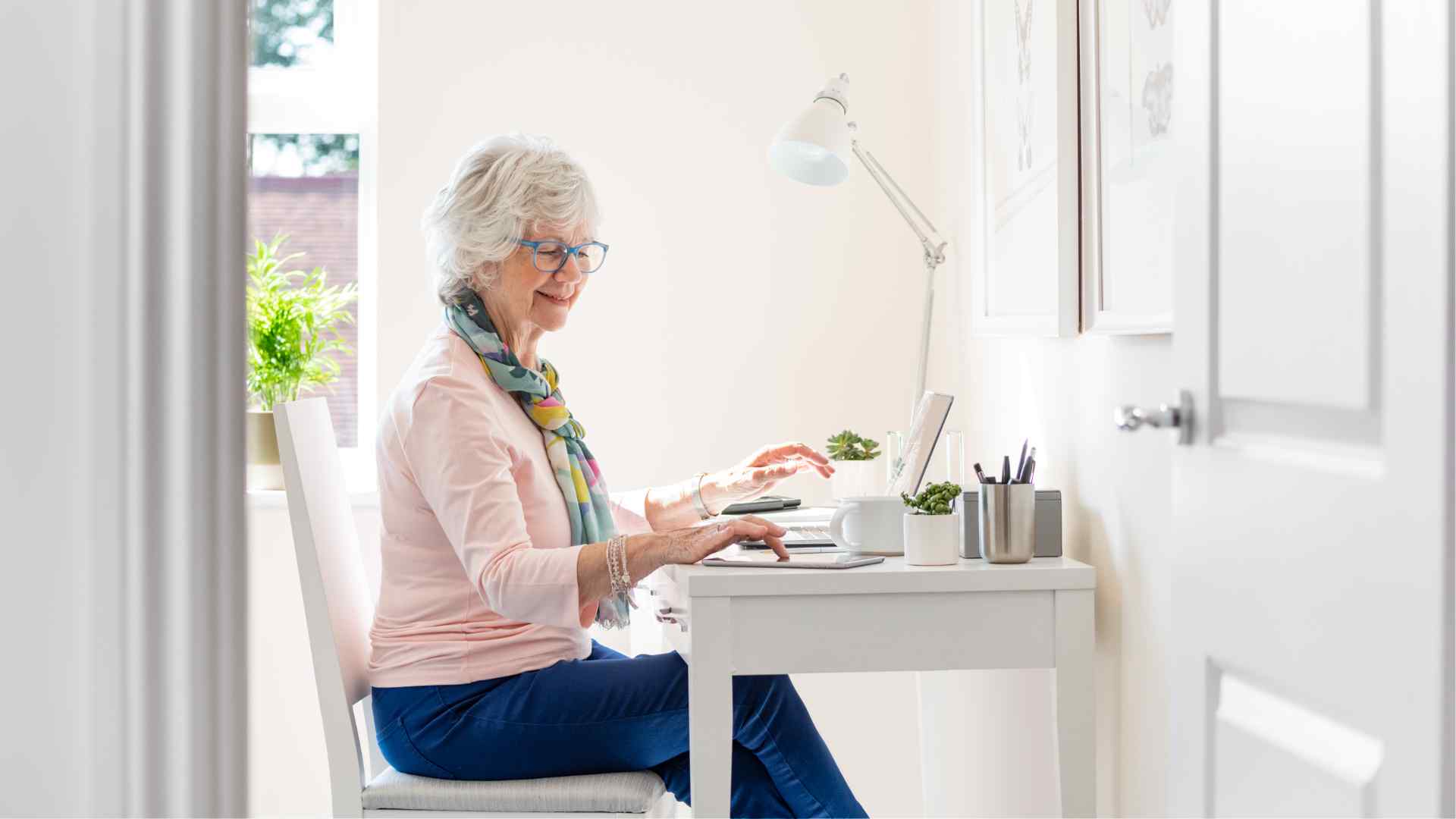 A woman sitting at her desk with a laptop