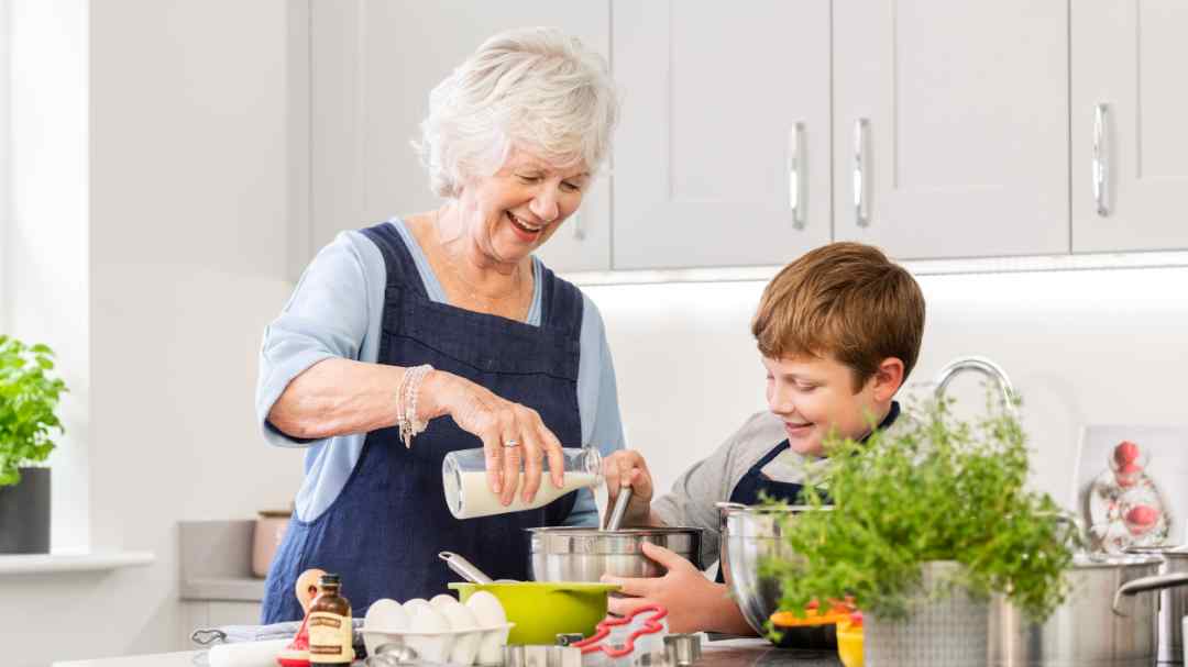 A grandmother and child baking together