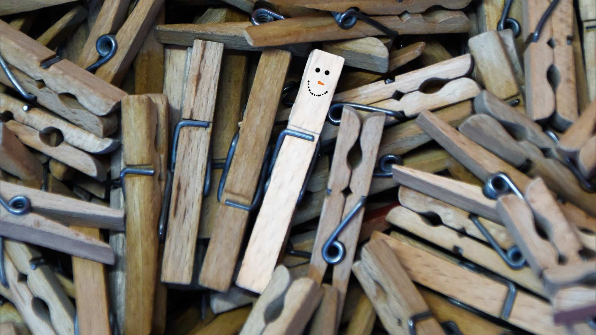 A pile of pegs, with one painted to look like a snowman