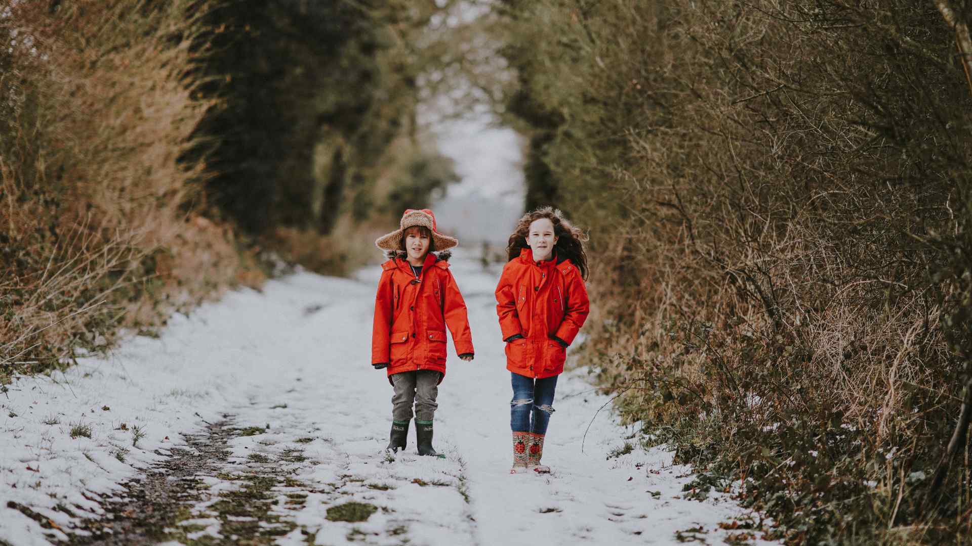 Two children walking in the snow