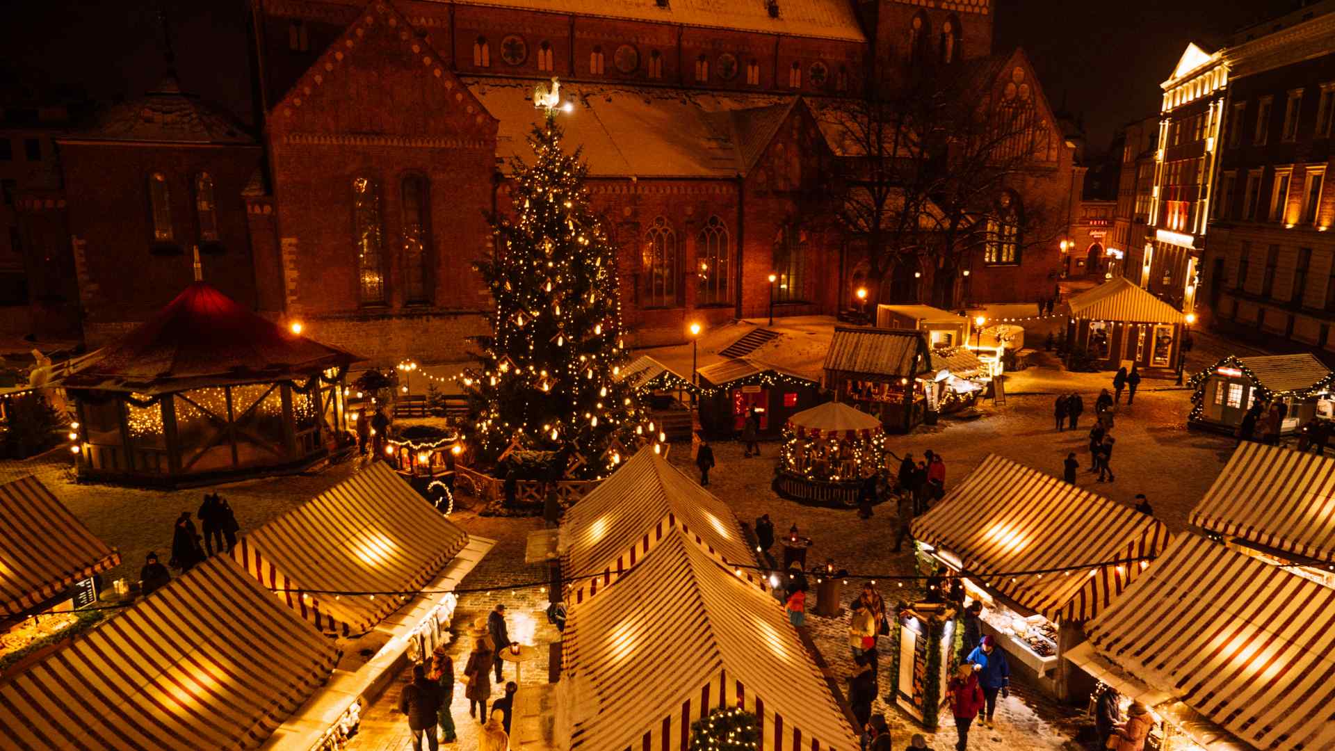 A christmas market with a lit tree