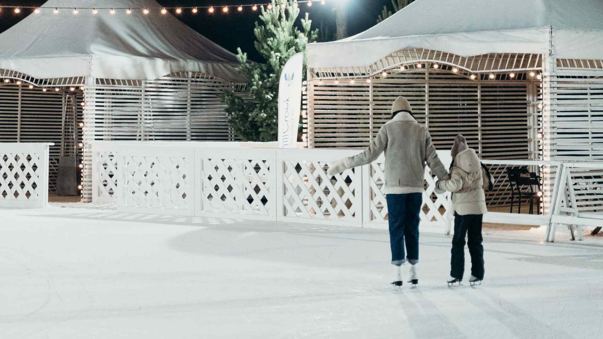 A mother and child ice skating